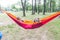 Happy little girls relax on hammock in nature