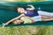 Happy little girls relax on hammock in nature