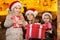 Happy little girls and their mummy with presents