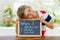 Happy little kid boy with chalk desk in hands. Healthy adorable child outdoors On desk When I grow up I want to be in