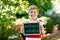 Happy little kid boy with chalk desk in hands. Healthy adorable child outdoors On desk - natural scientist - in German