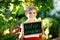 Happy little kid boy with chalk desk in hands. Healthy adorable child outdoors On desk - natural scientist - in German