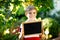 Happy little kid boy with chalk desk in hands. Healthy adorable child outdoors Empty desk for copyspace holding by