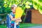 Happy little kid boy in colorful shirt and backpack or satchel and traditional German school bag cone called Schultuete