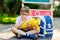 Happy little kid boy with glasses sitting by desk and backpack or satchel. Schoolkid with traditional German school bag