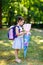 Happy little kid girl with backpack or satchel and big school bag or cone traditional in Germany for the first day of