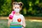 Happy little kid girl with medical mask, water bottle, apple and books. Schoolkid on first school day. Healthy child