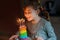 Happy little preschool girl celebrating birthday. Cute smiling child with homemade rainbow cake, indoor. Happy healthy