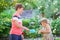 Happy little preschool girl and school kid boy having fun with blowing soap bubble blower. Children, lovely siblings