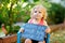 Happy little toddler girl with chalk desk in hands. Healthy adorable child outdoors On desk - When I grow up I want to