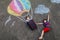 Happy little toddler girl and kid boy flying in hot air balloon painted with colorful chalks in rainbow colors on ground