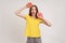 Happy lively excited young woman in yellow T-shirt holding half slice grapefruit, healthy raw fresh