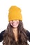 Happy long hair young woman in yellow beanie hat