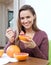 Happy long-haired girl eating grapefruit