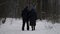 Happy long marriage, elderly spouses are walking together in winter park, rear view of pair