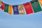 Happy Losar, Tibetan New Year background. Text on flags Om mani padme hum meaning The jewel is in the lotus.