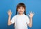 Happy lost tooth girl portrait, studio shoot on blue background