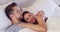 Happy, love and couple cuddle in bed in morning for bonding together in modern apartment. Smile, care and young man and
