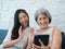 Happy lovely Asian senior woman, mother white hair and beautiful young female, daughter waving greeting at digital tablet screen.