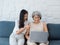 Happy lovely Asian senior woman, mother white hair and pretty young female, daughter pointing and looking at laptop computer.