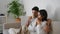 Happy lovers enjoying tea at home closeup. Love couple relaxing with coffee cups