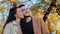 Happy lovers husband and wife ethnic multiracial married couple in autumn park smiling Caucasian woman with Hispanic man