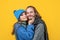 Happy loving affectionate man and woman lovers embrace yellow background, couple