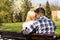 Happy loving caucasian couple sitting on a park bench, flirting on a sunny day