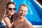 Happy loving couple Caucasian man and woman hugging and making selfie photo on background of pool. Smile and tanned skin