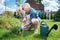 Happy loving couple feeling amazing while taking care of their flower bed