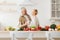 Happy loving couple, romantic dance on date in modern kitchen, smiling husband and wife celebrate anniversary