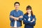 Happy loving couple. Studio shot of beautiful young couple in jeans wear standing and smiling