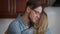 Happy loving man in eyeglasses hugging woman closing eyes enjoying closeness. Close-up portrait of affectionate