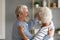 Happy loving married middle aged couple dancing in pair.