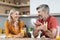 Happy loving spouses having fun while eating at kitchen