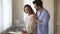 Happy loving young couple having fun preparing healthy meal together