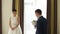 Happy luxury bride and groom standing at window