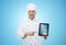 Happy male chef cook showing tablet pc