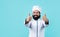 Happy male chef in hat with beard and moustache on blue background, thumbs up for success and perfection