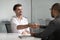 Happy male job applicant manager get hired handshaking hr client