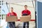 Happy Male Movers Holding Cardboard Boxes