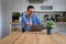 Happy male professional discussing over video call on laptop while sitting at desk in home office