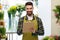 Happy male seller with clipboard at flower shop