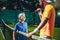 Happy male talking with kid on court