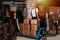 Happy male warehouse worker leaning on stack of carton boxes on a pallet jack