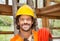 Happy Male Worker With Pipe At Construction Site