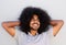 Happy man with afro looking relaxed with hands in hair