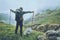 Happy Man backpacker hiking in foggy mountains