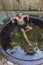 Happy man bathing in the cast iron vat with mineral water containing hydrogen sulphide. Water in cast iron vats heated to 40-45