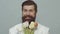 Happy man with bouquet of tulips for birthday. Bearded man holds flowers. Valentines Day. Womens Day. Spring holiday